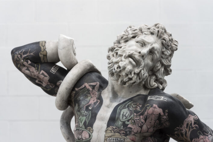 This recreation of Laocoon is tattooed over a black color to make the images more prevalent.