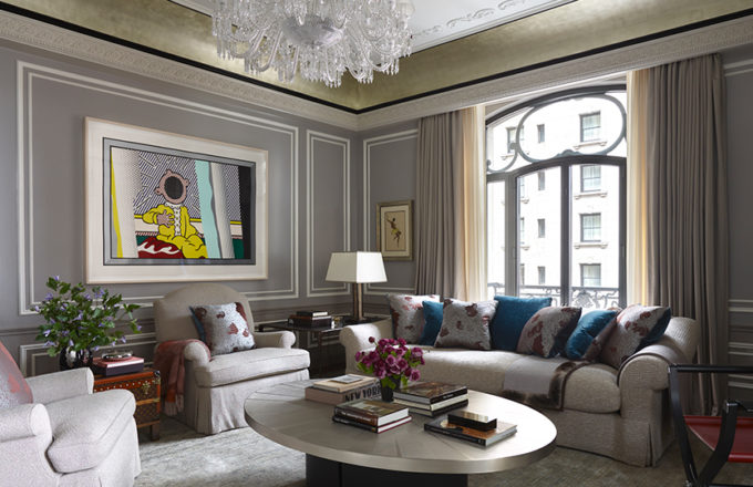 St. Regis, NY owner’s suite living room view featuring Baccarat chandelier and artwork by Roy Lichtenstein