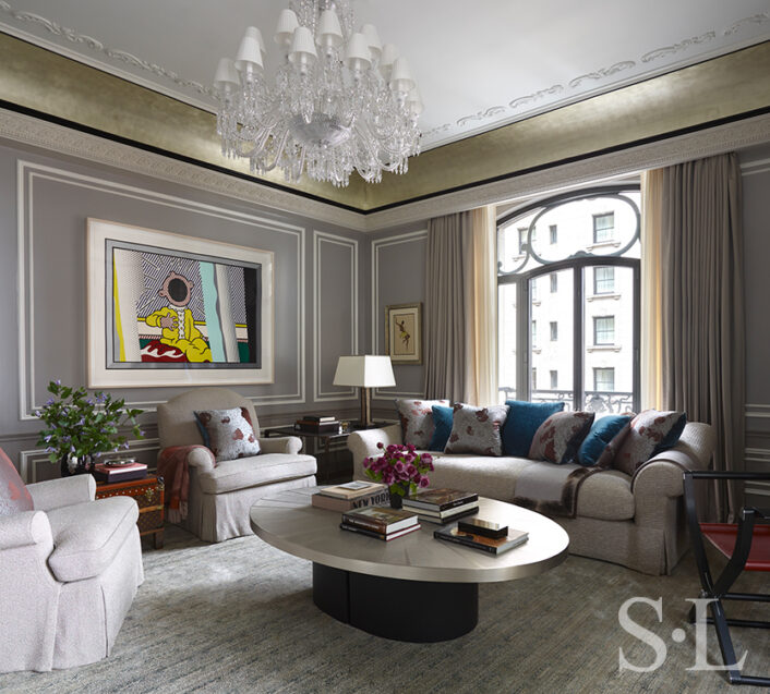 St. Regis, NY owner’s suite living room view featuring Baccarat chandelier and artwork by Roy Lichtenstein