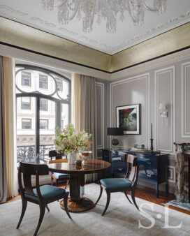 St. Regis, NY owner’s suite living room view featuring a custom Frank Pollaro table in Macassar ebony and artwork by Gordon Parks