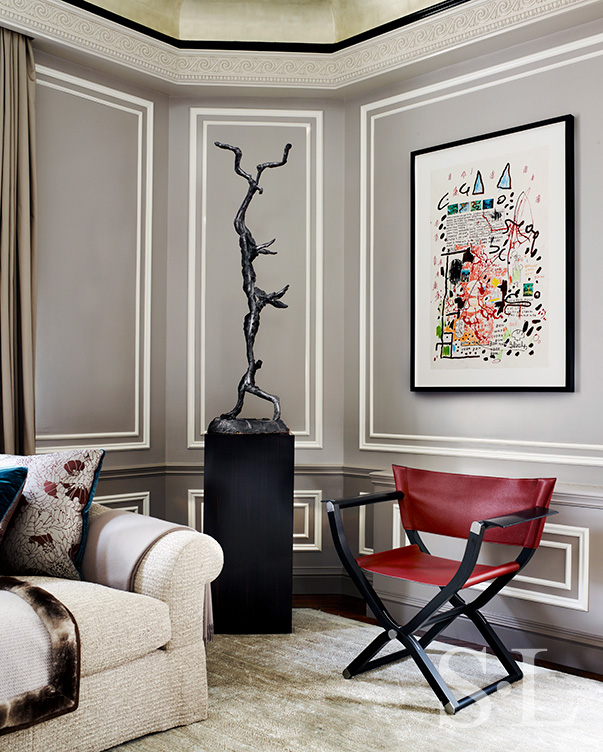 St. Regis, NY owner’s suite living room detail view featuring an Hermes chair and artwork by Jean-Michel Basquiat