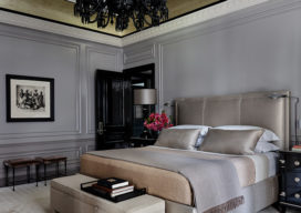St. Regis, NY owner’s suite primary bedroom featuring artwork by Irving Penn and Baccarat chandelier