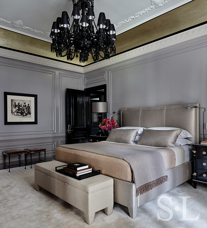 St. Regis, NY owner’s suite primary bedroom featuring artwork by Irving Penn and Baccarat chandelier