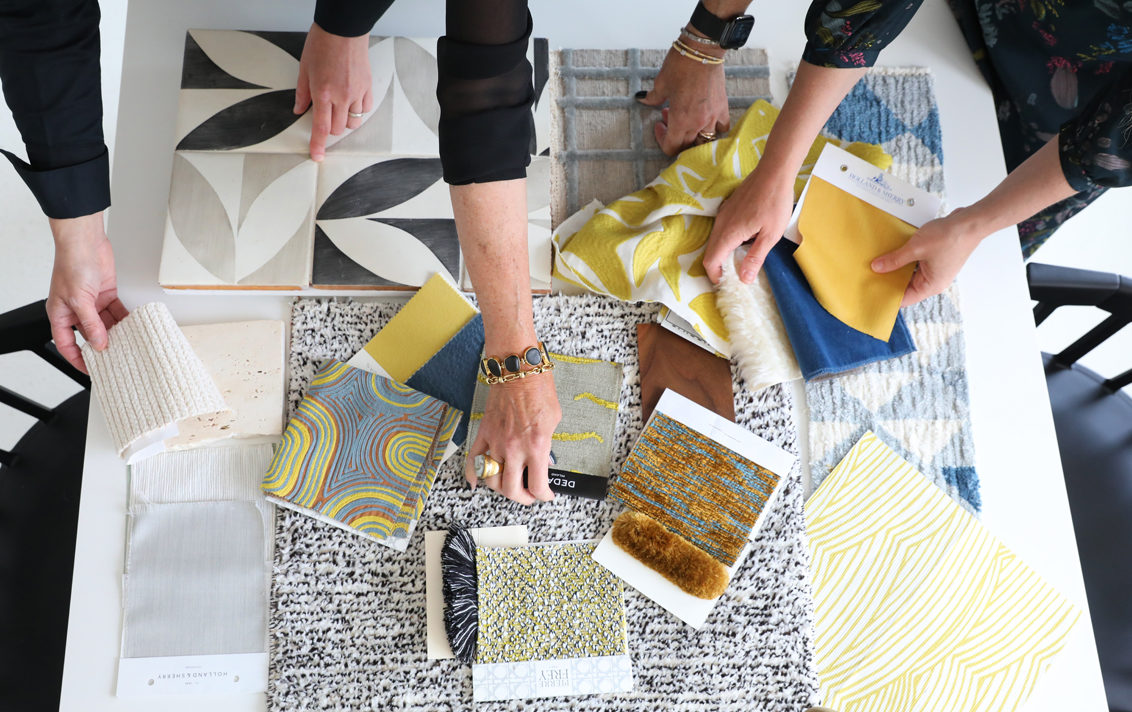 Suzanne Lovell Inc. interior architects and interior designers studying fabrics for a residential project