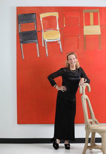 Interior designer Suzanne Lovell in her Chicago studio with a chair by Christian Astuguevieille and artwork by Daniel Kohn