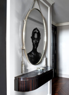 St. Regis, NY owner’s suite entry with artwork by Nick Knight reflected in an original Ruhlmann mirror
