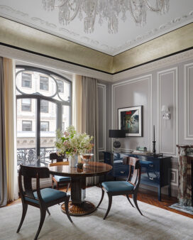 St. Regis, NY owner’s suite living room view featuring a custom Frank Pollaro table in Macassar ebony and artwork by Gordon Parks