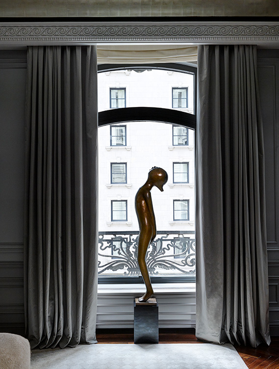 St. Regis, NY owner’s suite primary bedroom detail view with sculpture by Hugo Robus and drapery by Jouffre