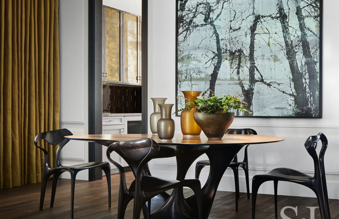 Dining room in Lincoln Park residence with table and chairs by Joseph Walsh and artwork by Irish painter Elizabeth Magill