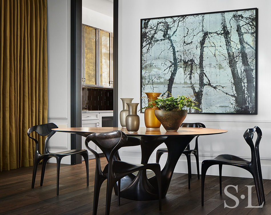 Dining room in Lincoln Park residence with table and chairs by Joseph Walsh and artwork by Irish painter Elizabeth Magill