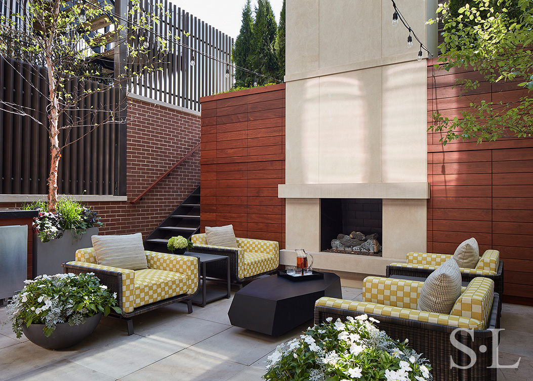 Outdoor living space at Lincoln Park residence with seating area and fireplace
