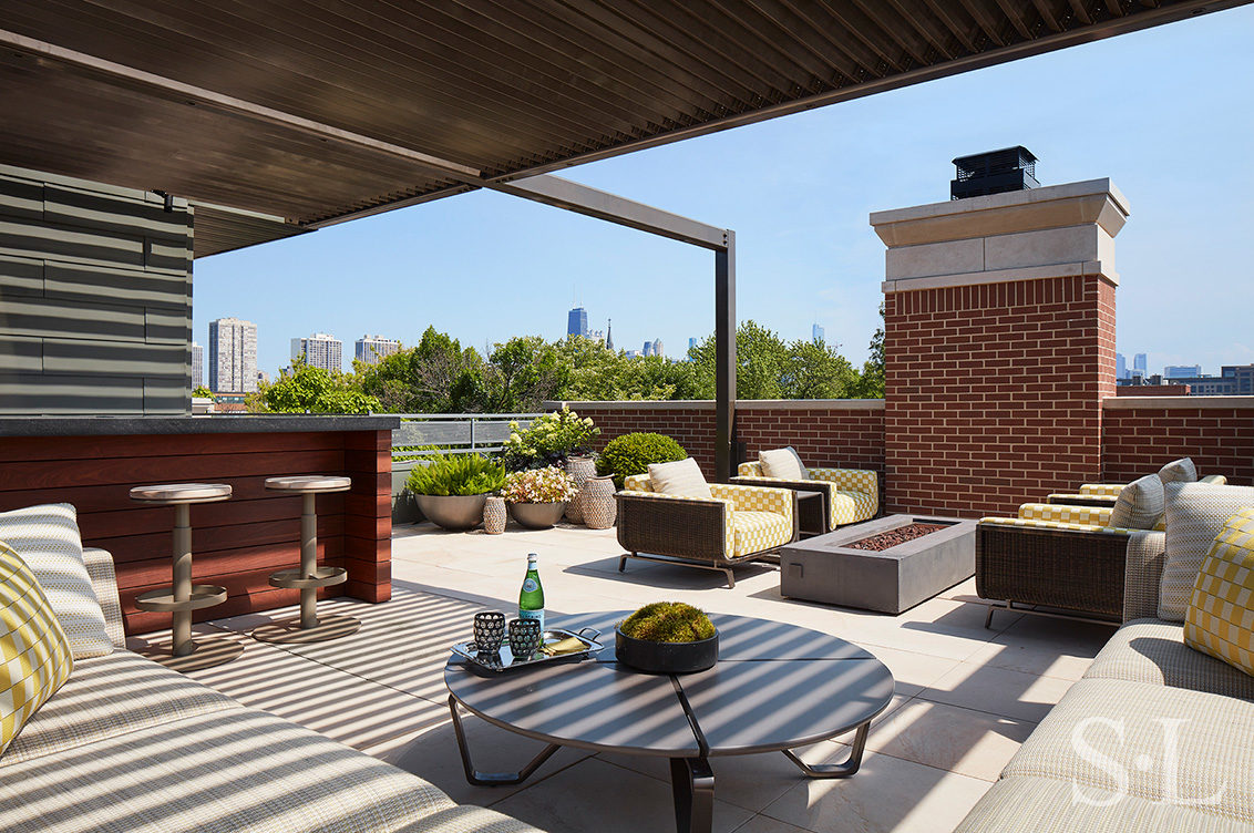 Outdoor living space at Lincoln Park residence with wet-bar and multiple seating areas