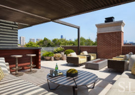 Outdoor living space at Lincoln Park residence with wet-bar and multiple seating areas