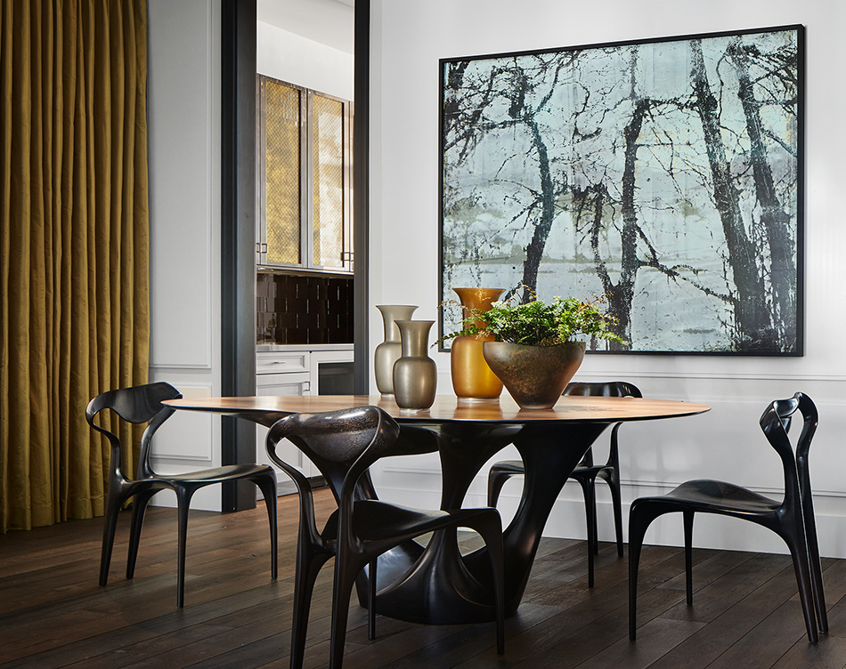 Dining room in Lincoln Park residence with table and chairs by Joseph Walsh and artwork by Irish painter Elizabeth Magill