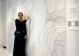 Suzanne Lovell with sketch of doors by Caleb Woodard