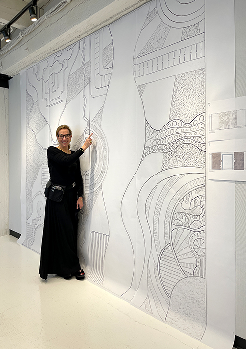 Suzanne Lovell with sketch of doors by Caleb Woodard