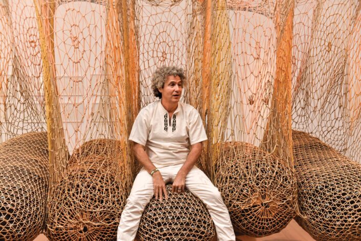 Ernesto Neto in front of an installation.