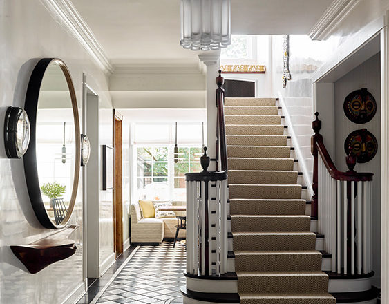 Foyer and stair of Oak Park Landmark Residence with black and white stone floor