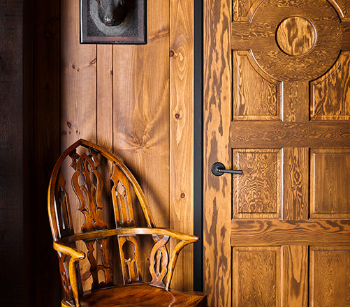 Lakeside residence detail with rustic interior design touches, knotty pine and carved deer head