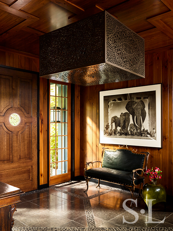 Lakeside residence rustic front entryway with antique antler bench and artwork by Nick Brandt