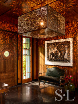 Lakeside residence rustic front entryway with antique antler bench and artwork by Nick Brandt