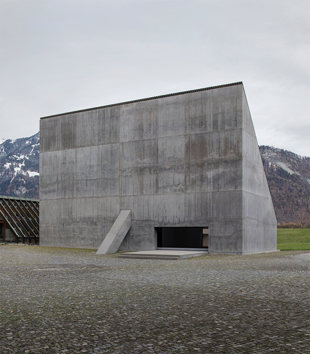 The Plantahof Auditorium's sloped concrete exterior by Valerio Olgiati