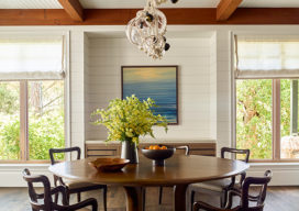 Dining room of luxury vacation residence on Hilton Head Island with shiplap walls and Lindsey Adelman chandelier