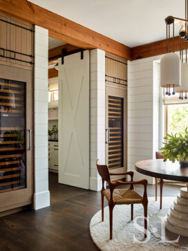 Wine room of luxury vacation residence on Hilton Head Island white shiplap walls and barn doors