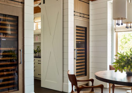 Wine room of luxury vacation residence on Hilton Head Island white shiplap walls and barn doors