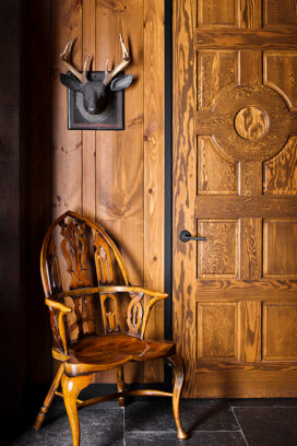 Lakeside residence detail with rustic interior design touches, knotty pine and carved deer head