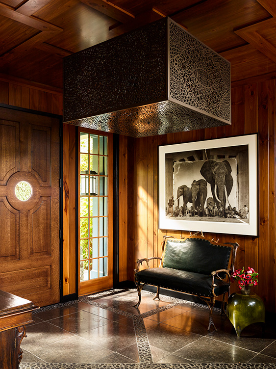 Lakeside residence rustic front entryway with antique antler bench and artwork by Nick Brandt
