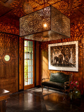 Lakeside residence rustic front entryway with antique antler bench and artwork by Nick Brandt
