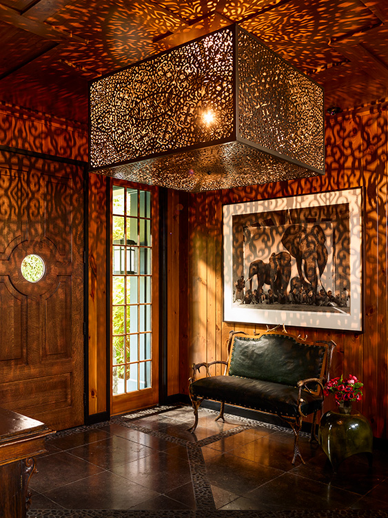 Lakeside residence rustic front entryway with antique antler bench and artwork by Nick Brandt