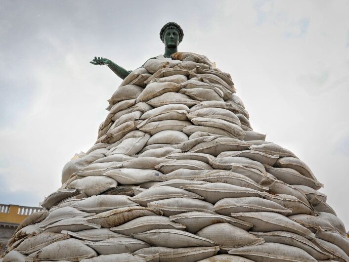 A monument is covered for protection.