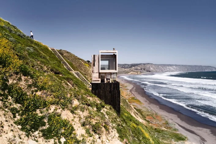 TWO CABINS LOOK OUT OVER THE PACIFIC OCEAN ALONG THE COAST OF CHILE.