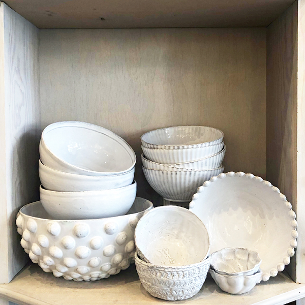 An assortment of different bowls by Astier de Villatte.