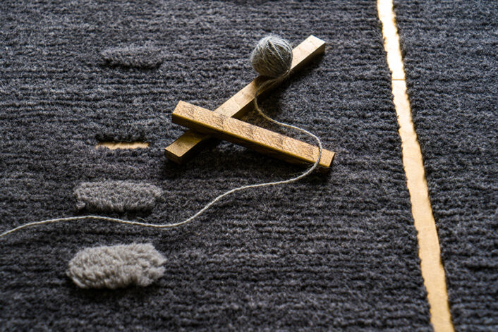 Detail of ERDEN’s ‘Emergent’ rug in alpaca studded with polished metal inlay.