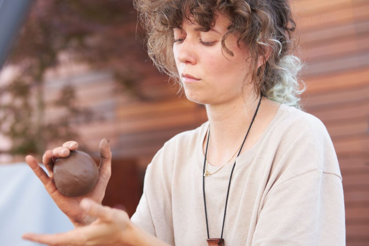 Golovina molding a ball of clay in her studio.