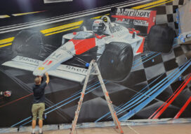 Formula 1 mural being painted in car condo designed by Suzanne Lovell
