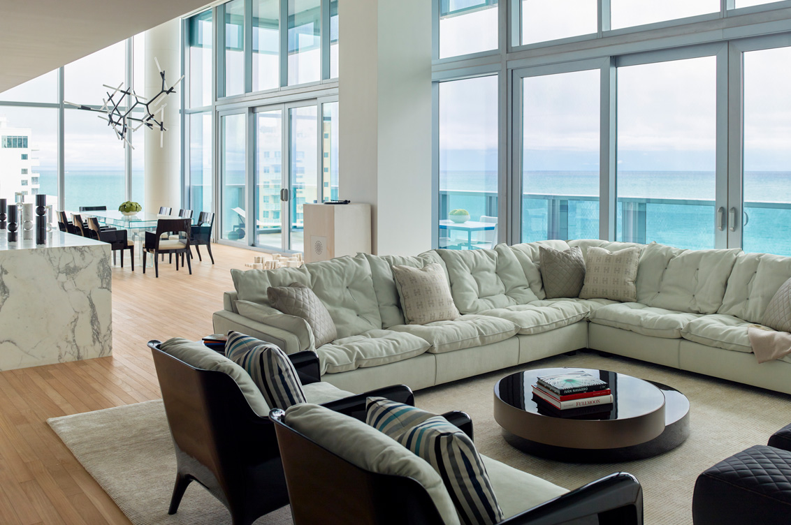 Miami Beach Edition residence great room with full wall of windows facing the ocean, architecture and interior design by Suzanne Lovell Inc.